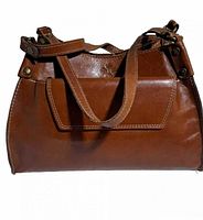 Front view of brown leather handbag showing handles, snap-flap detail and overall form