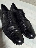 Top view of both shoes showing wingtip brogue pattern and laces