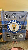 Full view of gray fleece NHL blanket showing all Original Six team logos and central 'Original Six Vintage Hockey' emblem.