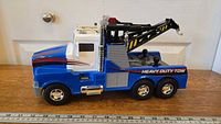 Side view of the large blue and white heavy duty tow truck toy, showing detailed decals and wheels.