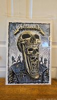 Full front view of Metallica VIP poster inside protective plastic showing the entire artwork.