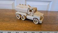 Right side view of the wooden Tonka tanker truck showing the tanker with the Tonka logo, six wheels, and cab details.