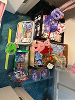 Overview of loose and packaged Ty Beanie Babies with milk crate