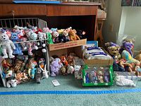 Wide view showing metal rack and boxes filled with numerous Ty Beanie Babies and some boxed sets