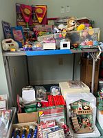 Full view of grey folding card table holding various items
