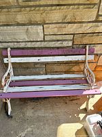 Front view of full bench showing weathered wood slats and metal sides