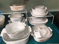 Overall lot showing lidded casseroles, bakers and ramekins on countertop and rack