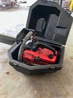 Chainsaw inside open carrying case