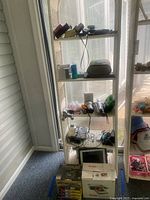 Full view of shelving unit showing entire assortment of electronic items