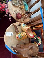 Overview showing elephant, clogs, framed fans, small animal figurine group