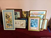 Group shot showing assortment of framed art pieces leaning together