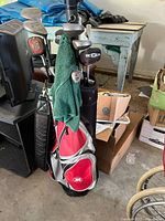 Bag and clubs front view showing red/gray bag, towel and club heads