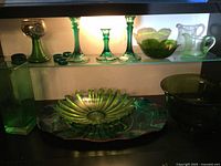 Overall view of green glassware, plastic bowl, metal tray setup
