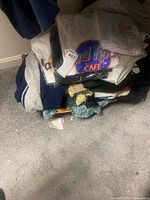 Stack of Hard Rock Café T-shirts on top of assorted pants