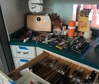 Overall view showing bread box, knife block, thermos, assorted utensils on counter