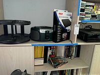 Overall lot showing CD rack, boombox, RCA antenna box and satellite receiver