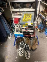 Stack of Everlast and other branded shoe boxes next to loose shoes