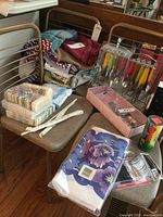 Overall lot with boxed cake set, flatware in stand, linens, napkins, utensils