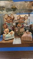 Front view of four PenDelfin rabbit figurines on shelf