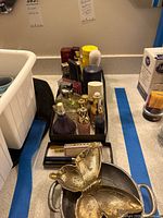 Tray of assorted perfume bottles and metal dishes