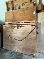 Large wood floor panel underside with feet and wiring