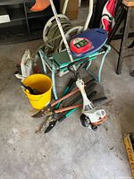 Overview showing trimmer, hose reel, kneeler, bucket and loppers