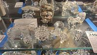 Full view of all crystal figurines and basket on glass shelf