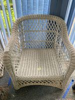 Front view of wicker armchair showing lattice back and seat