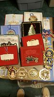 Overview of boxed and loose White House Christmas ornaments on table