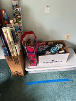 wrapping paper rolls, gift bags and bows in separate boxes