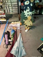 Lot overview showing wooden snowman, Noel figure, flags and umbrellas