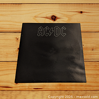 Front cover of AC/DC Back in Black album, black background with silver band logo.