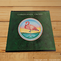 Front cover of Christopher Cross self-titled LP album featuring a flamingo illustration on a green background.