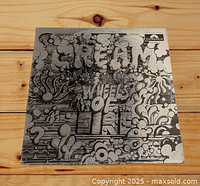 Front cover of Cream's 'Wheels of Fire' album showing black and white psychedelic artwork with band name and album title