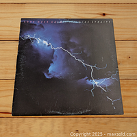 Front cover of Dire Straits "Love Over Gold" vinyl LP showing lightning artwork and album title.