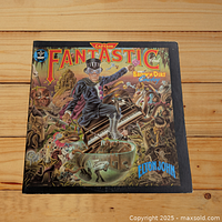 Front cover of Elton John Captain Fantastic and the Brown Dirt Cowboy vinyl LP showing colorful fantasy illustration.