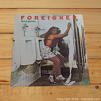 Front cover of the Foreigner Head Games vinyl LP showing the woman in restroom artwork.