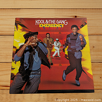 Front album cover of Kool & The Gang's Emergency showing band members and colorful background