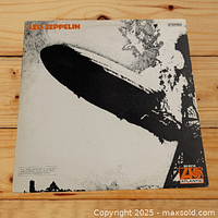 Front cover of Led Zeppelin self-titled debut album showing the Hindenburg disaster image with orange text and Atlantic Records logo.