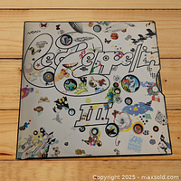 Front cover of Led Zeppelin III album showing colorful psychedelic collage artwork with band name and Roman numeral III.