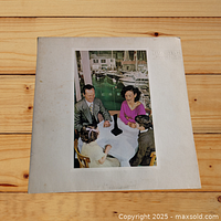 Front cover of Led Zeppelin Presence album featuring family dining scene and black obelisk.