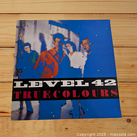 Front cover of Level 42 True Colours vinyl LP showing band members in pixelated, colorful artwork with 'Level 42 True Colours' text.