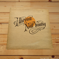 Front cover of Neil Young Harvest LP featuring the album title in ornamental typography on a cream background.