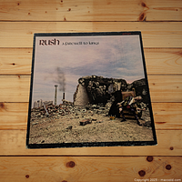 Front cover of Rush A Farewell to Kings vinyl record album showing the artwork with ruins and seated figure.