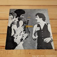 Front cover of Santana Inner Secrets vinyl LP showing clapping band members and Carlos Santana.