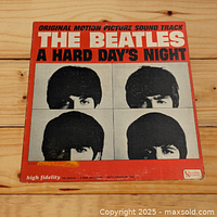 Front cover of The Beatles "A Hard Day's Night" LP showing original motion picture soundtrack title and band member photos on red background.