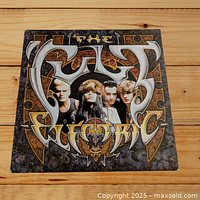 Front cover of The Cult 'Electric' vinyl LP showing band photo and styled text logo