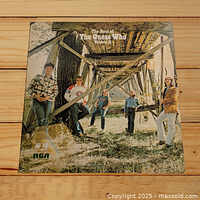 Front album cover of The Best of The Guess Who Volume II by The Guess Who, showing five band members standing under wooden trestle outdoors