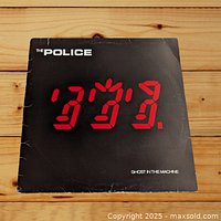 Front of The Police LP album cover 'Ghost in the Machine' showing graphic design and wear on edges.