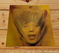 Front cover of The Rolling Stones Goats Head Soup LP showing stylized yellow image of a face behind translucent material.